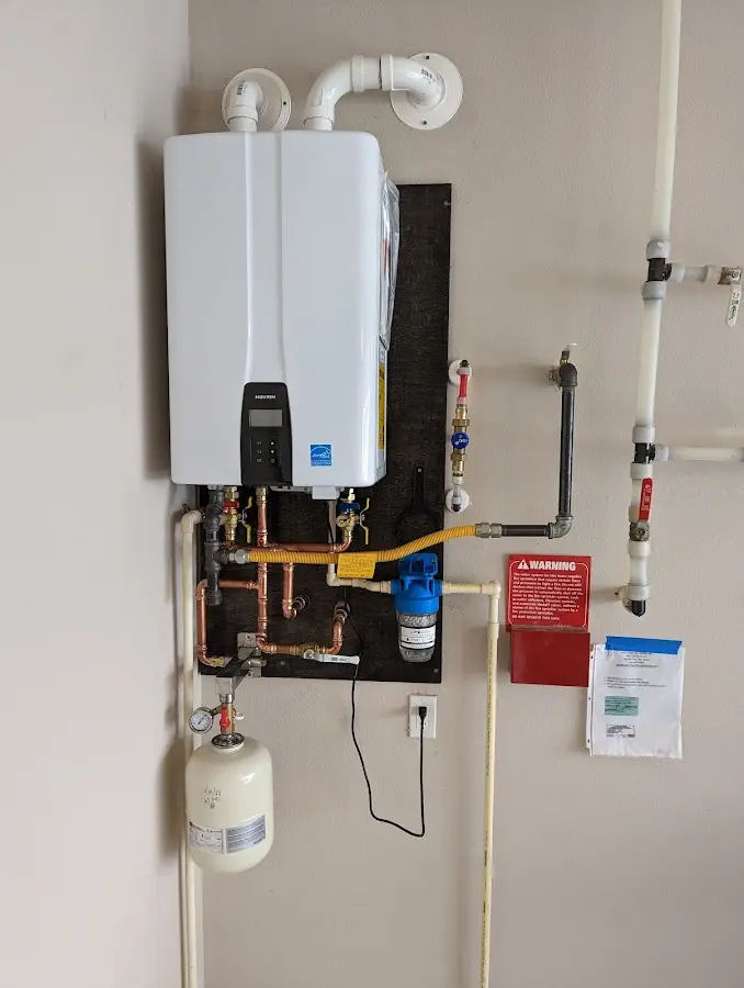 Professional plumber installing copper piping in a North Strabane home